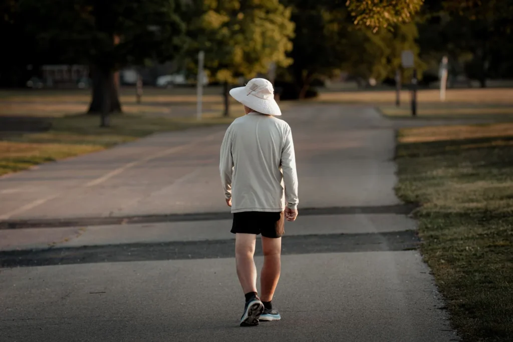 Man over 40 getting morning sunlight for sleep during an early outdoor walk