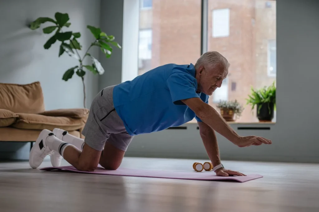 Mature man stretching his legs at home before bed